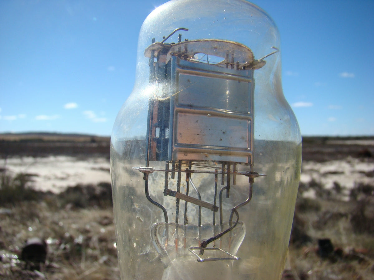 An old vacuum tube stands in a dry outdoor landscape